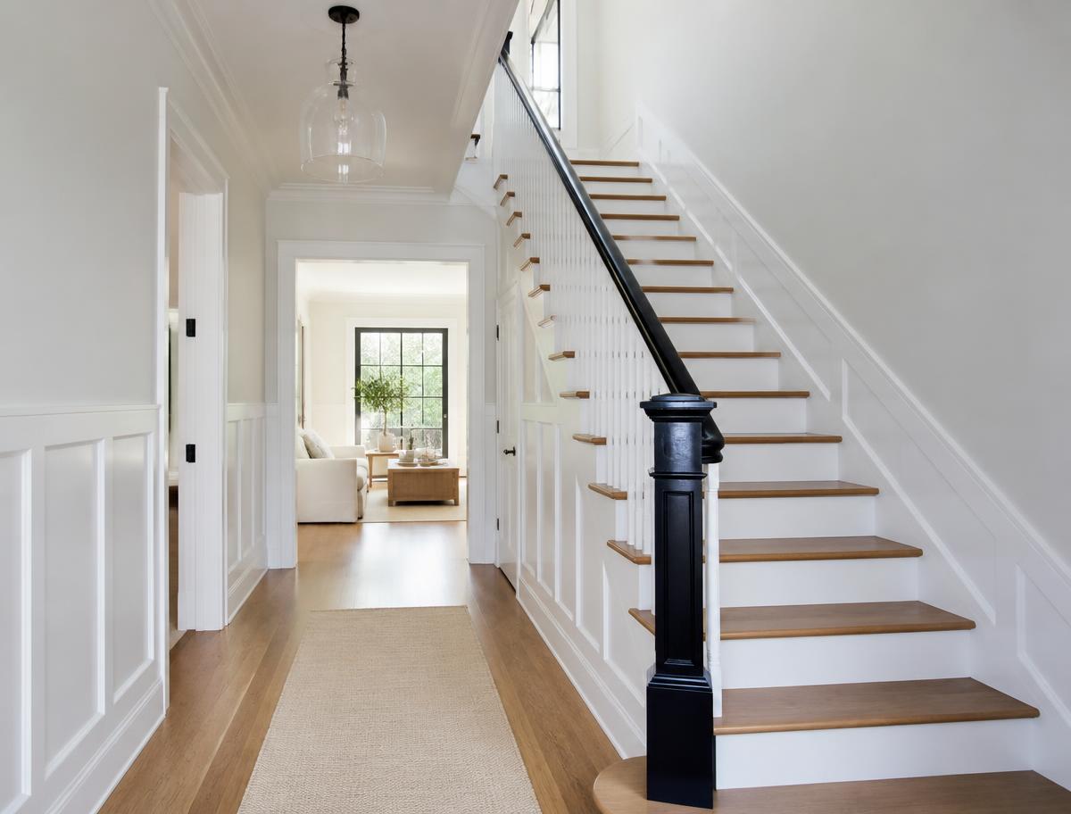 Hallway and staircase painted in clean white with fresh trim
